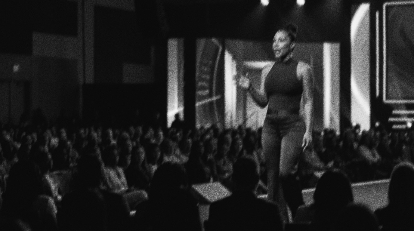 Ashley speaking on an intimate stage