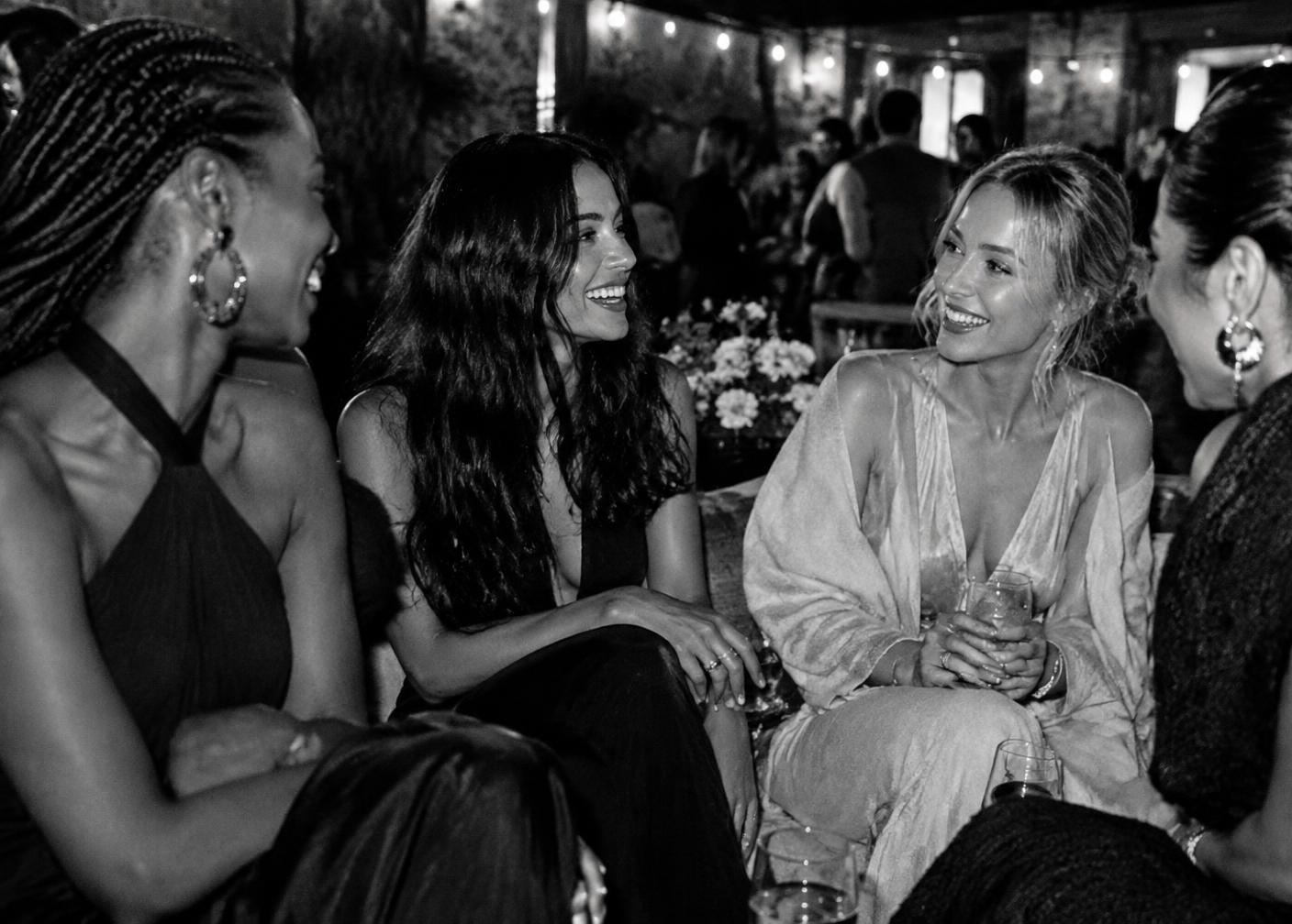 Women connecting at an intimate evening event